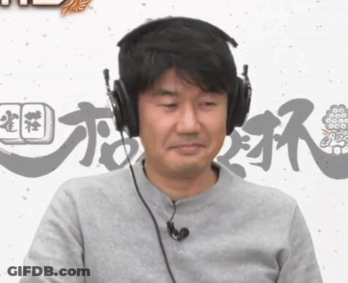 A Man Wearing Headphones And A Microphone Looks At The Camera GIF