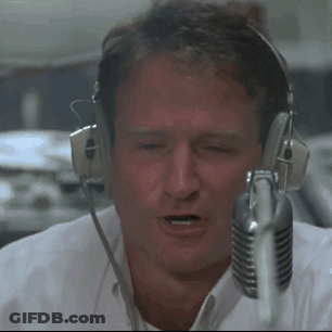 A Man Wearing Headphones And A Microphone Looks At The Camera GIF