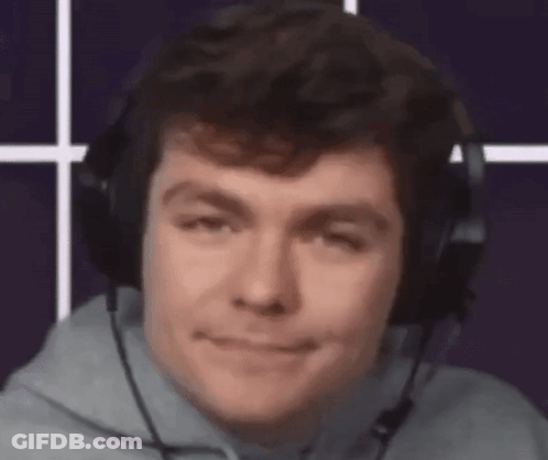 A Man Wearing Headphones And A Microphone Looks At The Camera . GIF