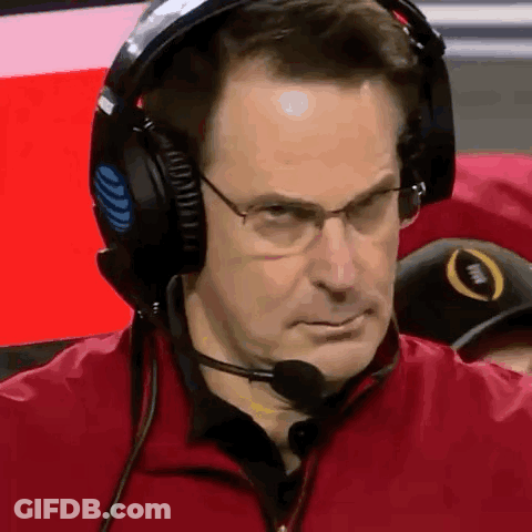 A Man Wearing Headphones And A Microphone Looks At The Camera . GIF