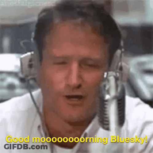A Man Wearing Headphones And A Microphone Says Good Morning Bluesky GIF