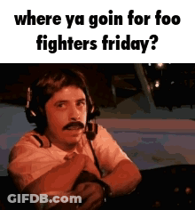 A Man Wearing Headphones And A Mustache Is Sitting In A Plane . GIF