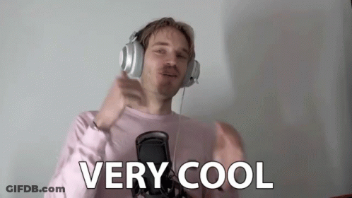 A Man Wearing Headphones And A Pink Shirt Is Giving A Thumbs Up Sign . GIF