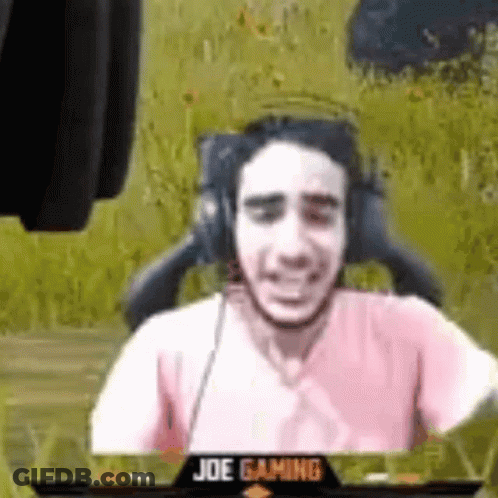 Man With Headphones And Pink Shirt In Gaming Chair GIF