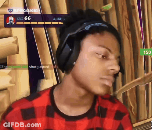 A Man Wearing Headphones And A Plaid Shirt Is Playing A Video Game With The Number 66 On The Screen Behind Him GIF