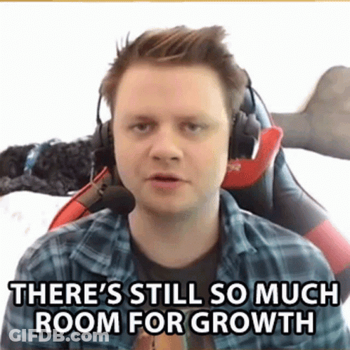 A Man Wearing Headphones And A Plaid Shirt Is Sitting In A Chair And Talking . GIF