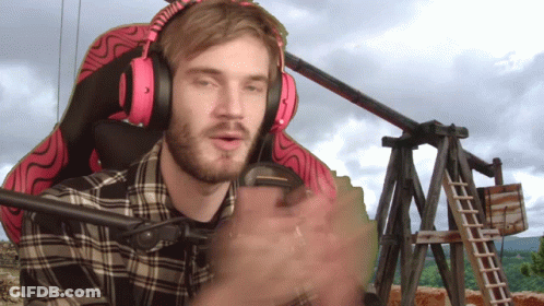 A Man Wearing Headphones And A Plaid Shirt Is Sitting In A Chair GIF