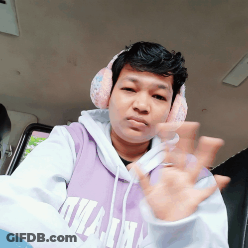 A Man Wearing Headphones And A Purple Hoodie That Says Kilian On It GIF