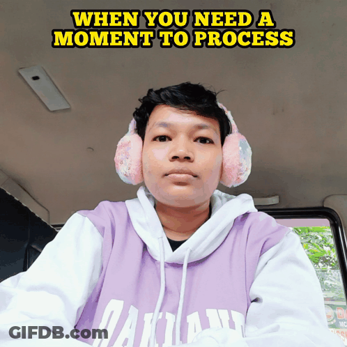 A Man Wearing Headphones And A Purple Hoodie With The Words When You Need A Moment To Process GIF