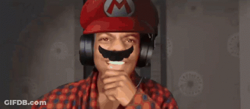 A Man Wearing Headphones And A Red Hat With A M On It GIF