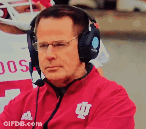 A Man Wearing Headphones And A Red Jacket With The Word Adidas On It GIF