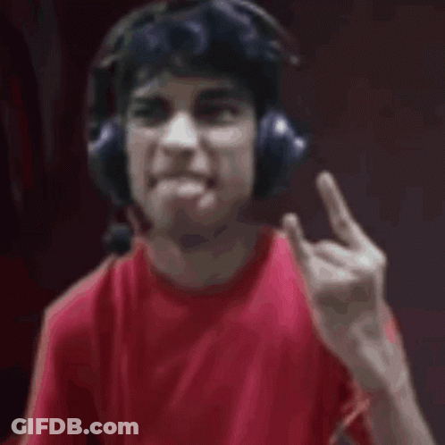 A Man Wearing Headphones And A Red Shirt Is Looking At The Camera . GIF