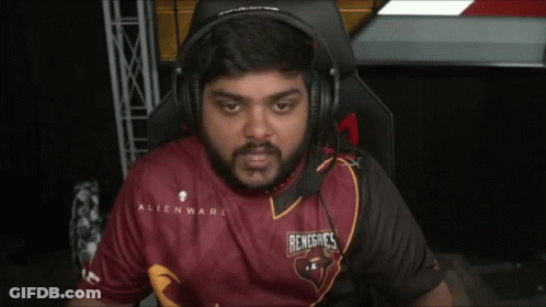 A Man Wearing Headphones And A Red Shirt Is Sitting In A Chair . GIF