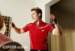 A Man Wearing Headphones And A Red Shirt With The Letter S On The Front GIF