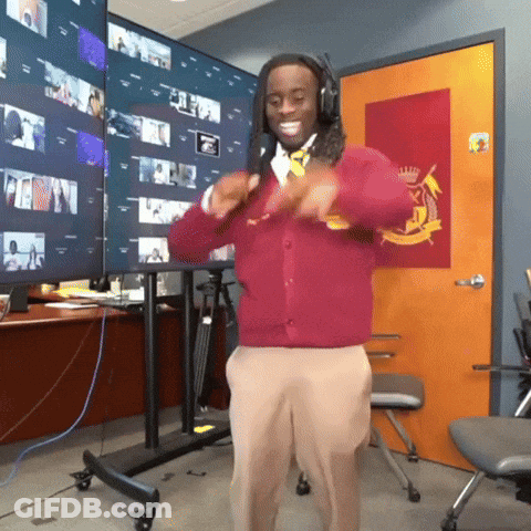 A Man Wearing Headphones And A Red Sweater Is Dancing GIF
