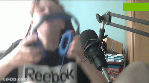 A Man Wearing Headphones And A Reebok Shirt GIF