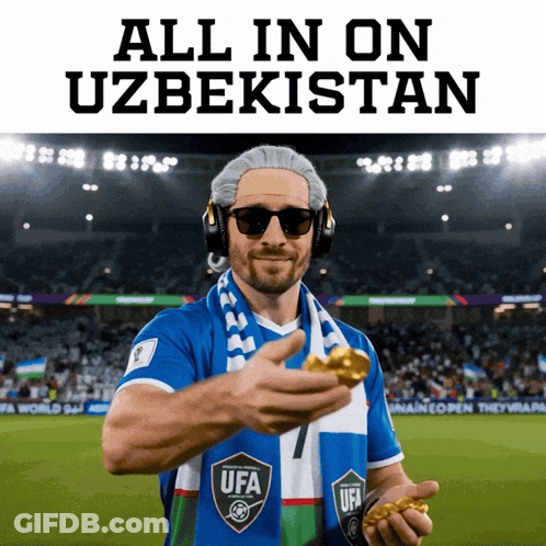 A Man Wearing Headphones And A Scarf With The Word Ufa On It Holds A Gold Medal GIF