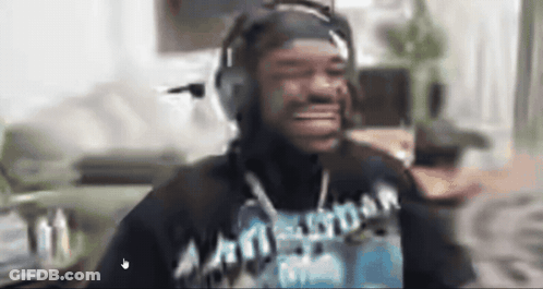 A Man Wearing Headphones And A Shirt That Says Amsterdam Is Smiling GIF