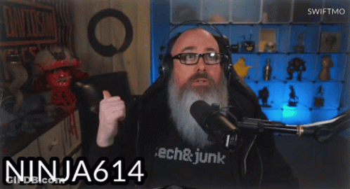 A Man Wearing Headphones And A Shirt That Says Tech & Junk GIF