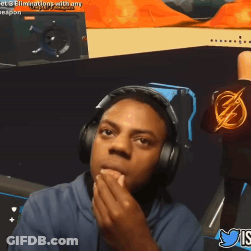 A Man Wearing Headphones And A Shirt With A Lightning Bolt On It Is Playing A Video Game GIF