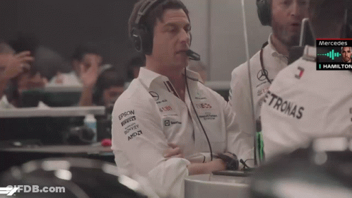 A Man Wearing Headphones And A Shirt With Petronas On It GIF