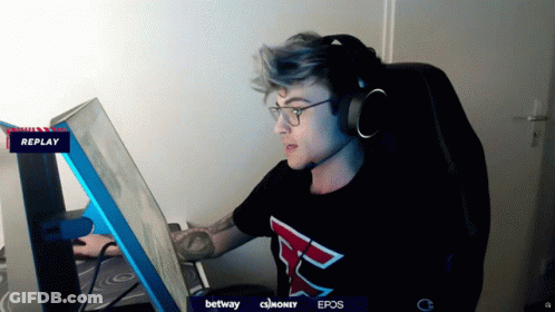 A Man Wearing Headphones And A Shirt With The Letter F On It Looks At A Computer Screen GIF