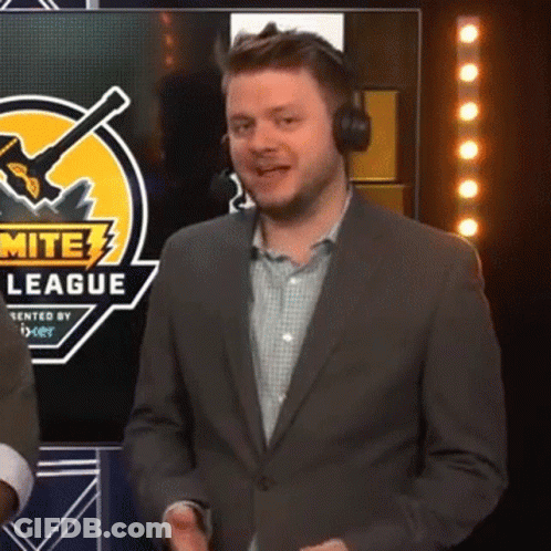 A Man Wearing Headphones And A Suit Is Standing In Front Of A Screen That Says Mite League GIF