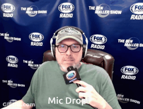 A Man Wearing Headphones And A T-Shirt That Says Mic Drop GIF