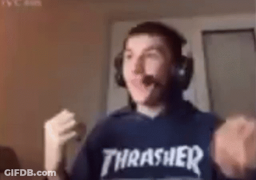 A Man Wearing Headphones And A Thrasher Sweatshirt Is Making A Fist . GIF