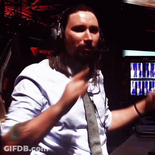 A Man Wearing Headphones And A Tie Is Dancing In Front Of A Red Bull Machine GIF
