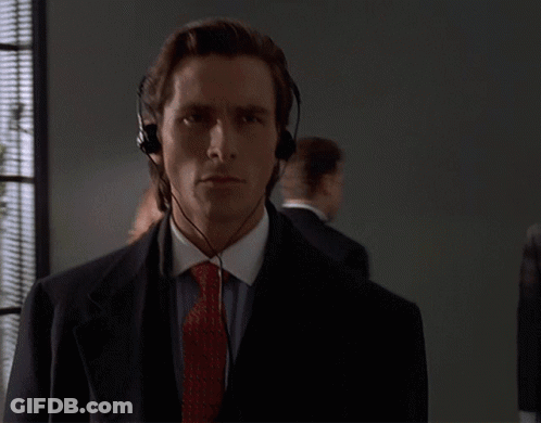 A Man Wearing Headphones And A Tie Looks At The Camera GIF