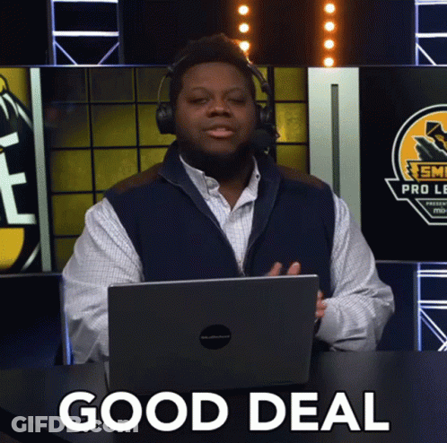 A Man Wearing Headphones And A Vest Is Sitting In Front Of A Laptop With The Words Good Deal Written On It GIF