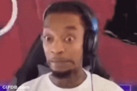 A Man Wearing Headphones And A White Shirt Is Making A Funny Face . GIF