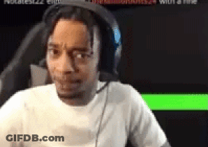 A Man Wearing Headphones And A White Shirt Is Sitting In Front Of A Computer Screen . GIF