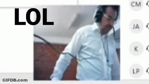 A Man Wearing Headphones And A White Shirt Is Standing In Front Of A Screen With The Words Lol On It . GIF