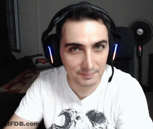 A Man Wearing Headphones And A White Shirt With A Picture Of A Skull On It GIF