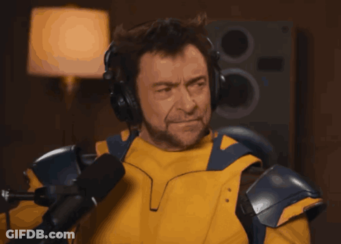 A Man Wearing Headphones And A Yellow Jacket GIF