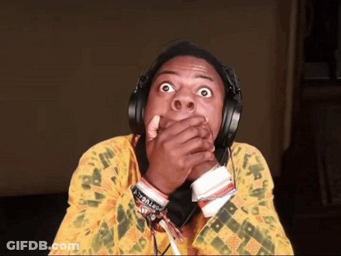 A Man Wearing Headphones And A Yellow Shirt Has A Bracelet On His Wrist That Says I 'M A Troll GIF