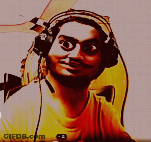 A Man Wearing Headphones And A Yellow Shirt Is Looking At Something GIF