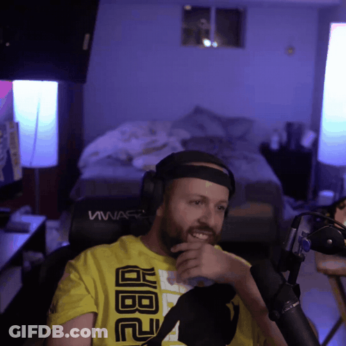 A Man Wearing Headphones And A Yellow Shirt That Says Abc GIF