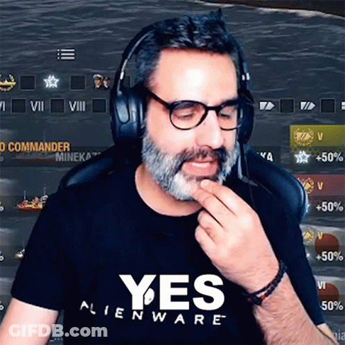 A Man Wearing Headphones And A Yes Alienware Shirt Is Playing A Video Game . GIF