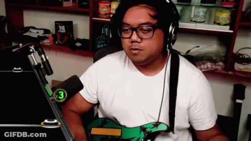A Man Wearing Headphones And Glasses Is Playing A Guitar GIF