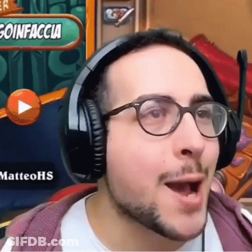 A Man Wearing Headphones And Glasses Is Playing A Video Game GIF