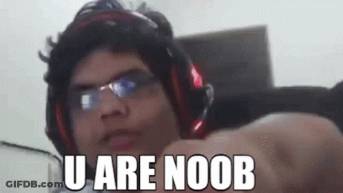 A Man Wearing Headphones And Glasses Is Pointing At The Camera With The Words `` U Are Noob '' Written On His Face . GIF