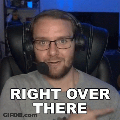 A Man Wearing Headphones And Glasses Is Pointing To The Right And Saying Right Over There GIF