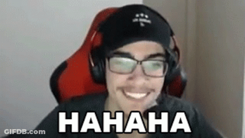 A Man Wearing Headphones And Glasses Is Sitting In A Chair And Laughing . GIF