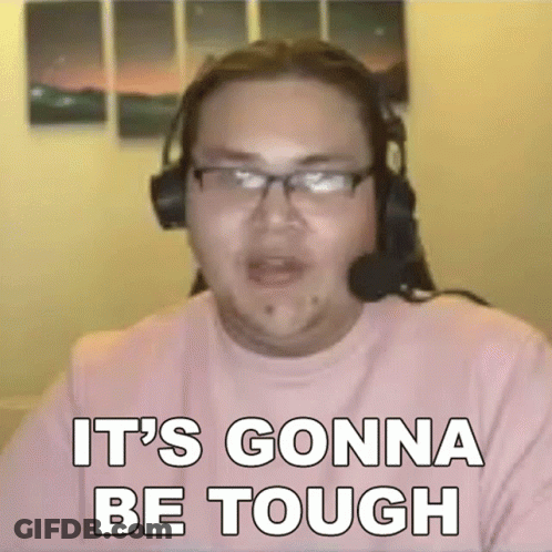 A Man Wearing Headphones And Glasses Is Sitting In Front Of A Computer Screen . GIF