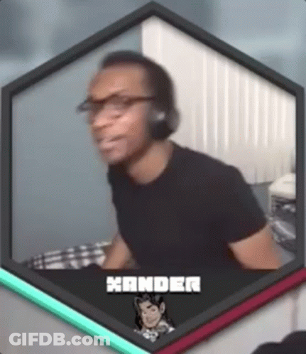 A Man Wearing Headphones And Glasses Is Sitting In Front Of A Computer Screen . GIF