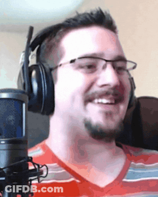 A Man Wearing Headphones And Glasses Is Smiling GIF