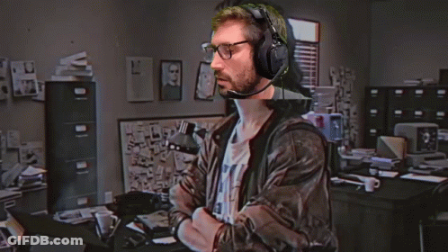 A Man Wearing Headphones And Glasses Is Standing In Front Of A Hackerman Logo GIF